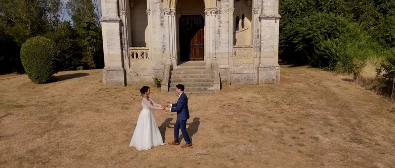 Les mariés face à face devant la chapelle en pierre du Château de Laverdines