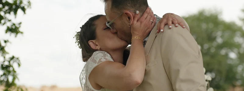 Le baiser des mariés pendant la cérémonie au Domaine des Médards