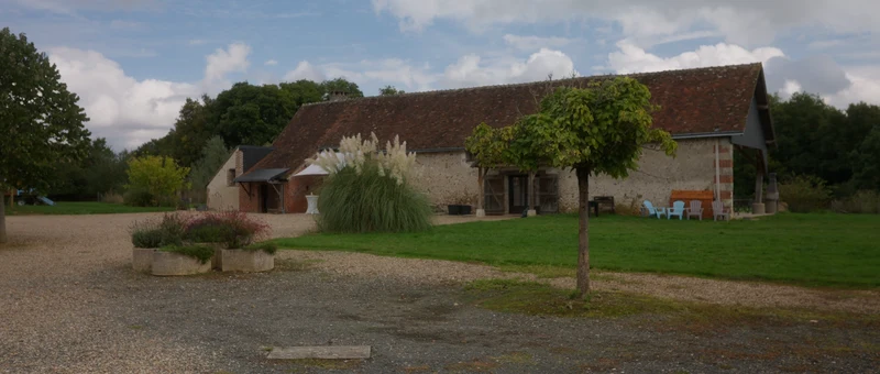 Le corps de ferme de La Grange de Fossillon, sa cour en gravier et sa pelouse